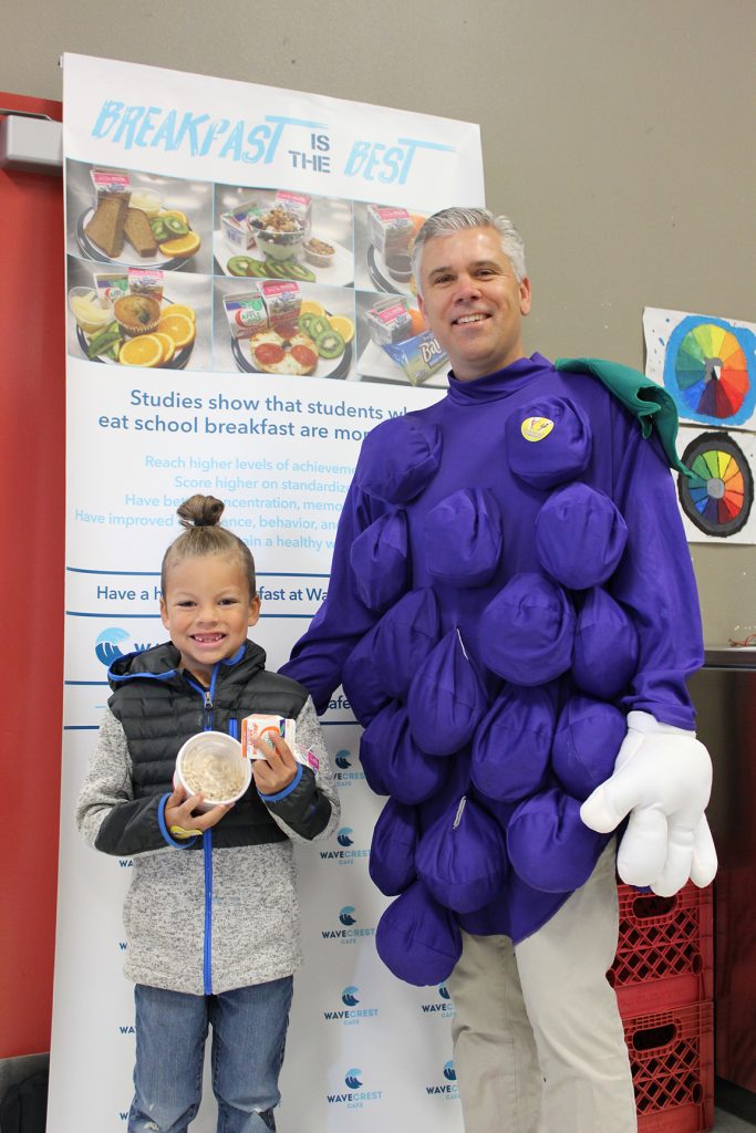 Assistant Principal Korporall in a grape costume with student