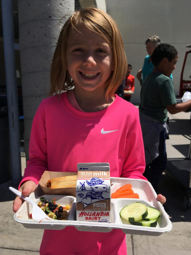 A girl with her school lunch tray