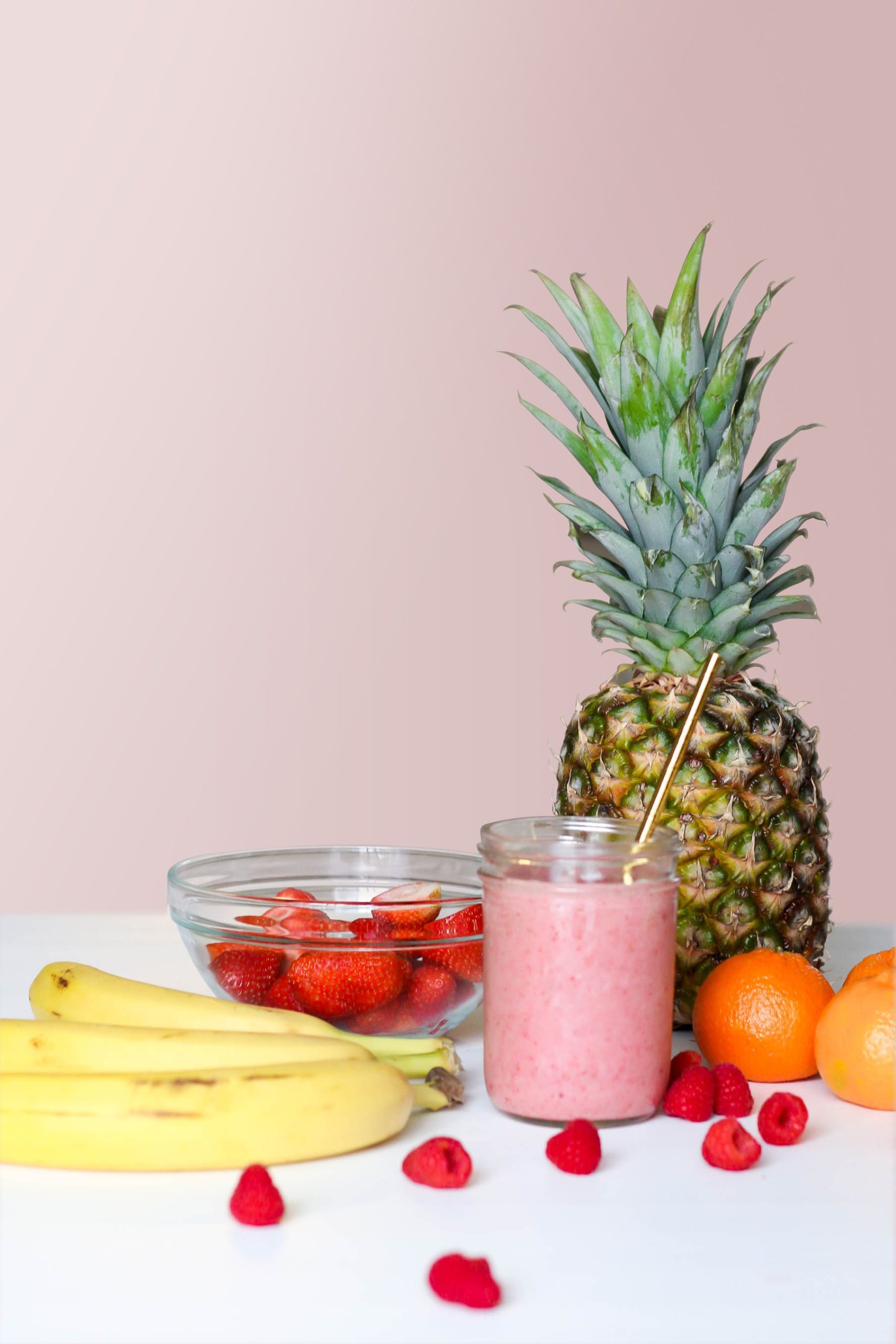 Fruit smoothie with strawberries, pineapple, banana, oranges, and respberries