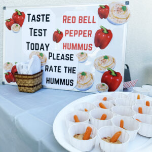 Taste test sign featuring roasted red pepper hummus