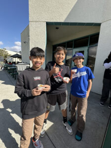 Trio of boys at a taste test at Roosevelt Middle School